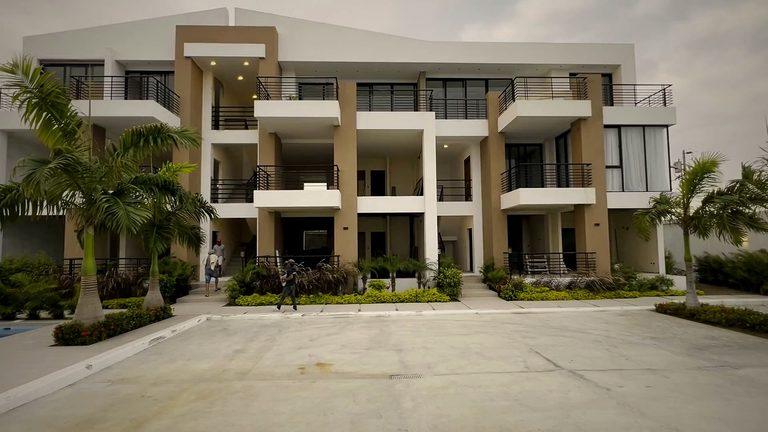 Coastline Condos residences with courtyard pool and palms at golden hour, Playas, Ecuador