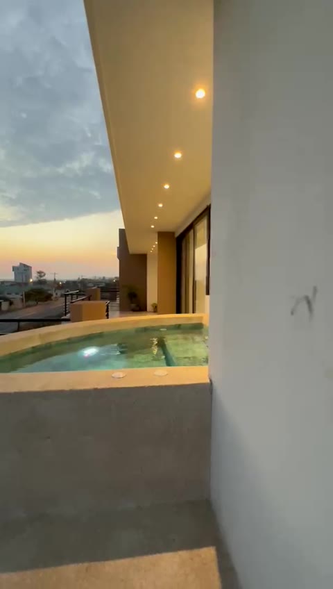 Private terrace plunge pool at sunset — model residence, October 2026